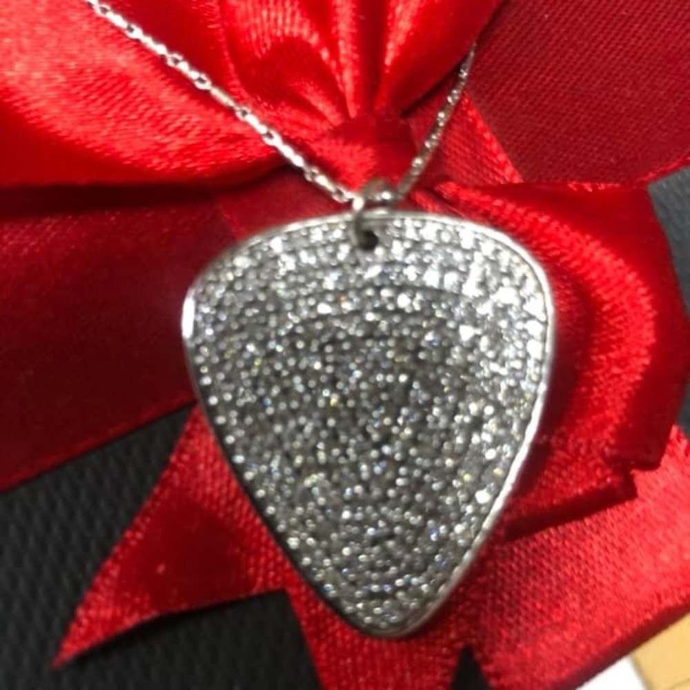 Beautiful custom guitar pic diamond pendant.